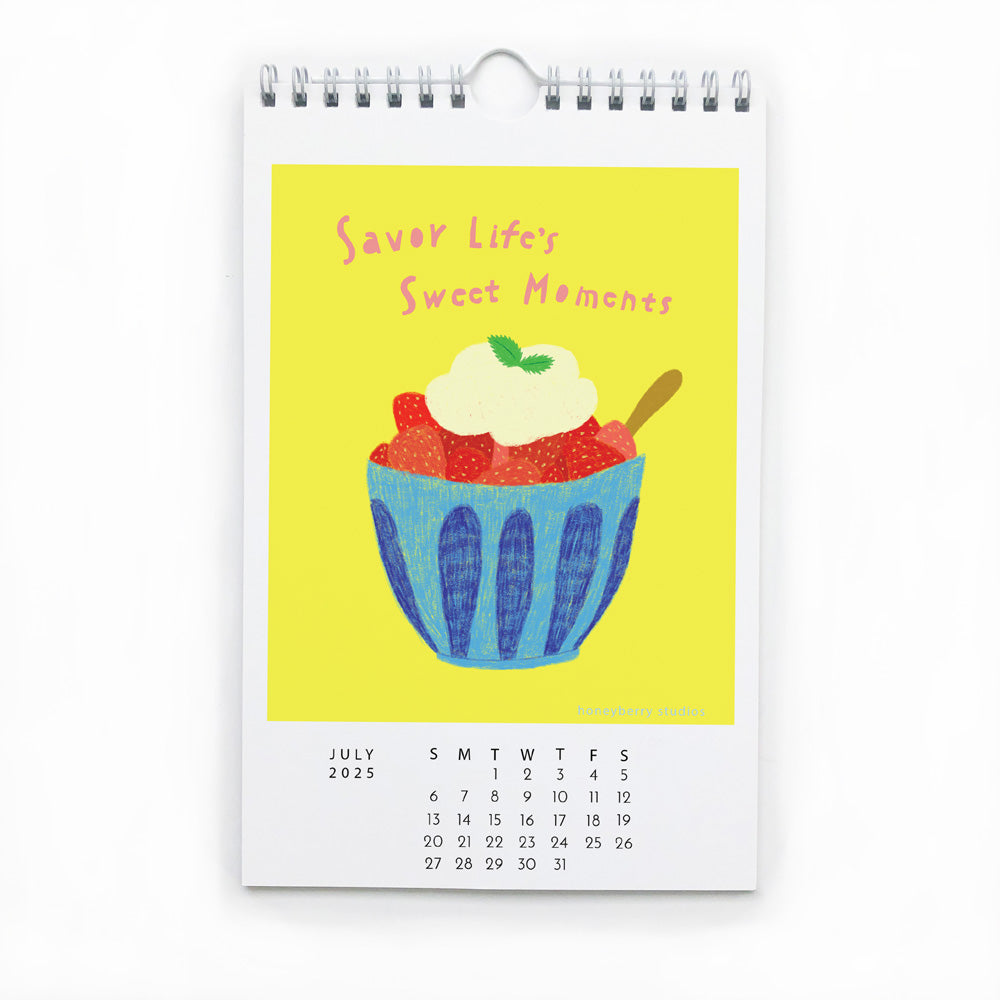 Colorful wall calendar page for July 2025 featuring cheerful illustration of dessert bowl with text "Savor Life's Sweet Moments" on bright yellow background