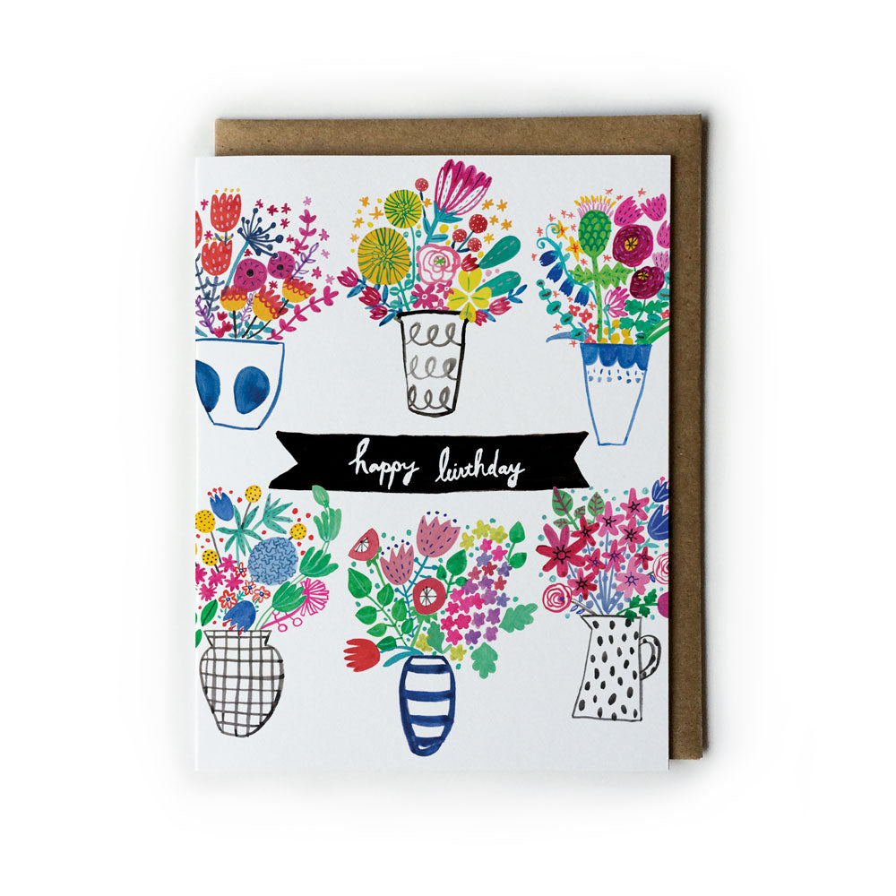 Colorful spring bouquet birthday card featuring six illustrated vases with vibrant flowers, a 'happy birthday' banner, and a kraft paper envelope