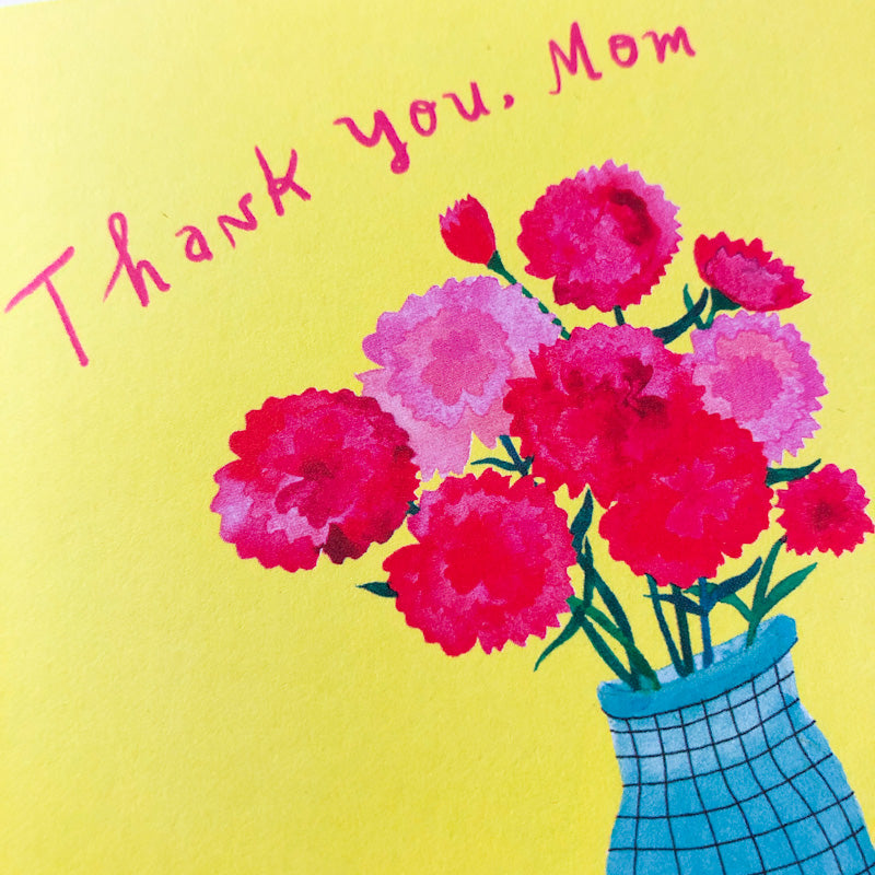 Colorful Mother's Day card featuring pink and red carnations in a blue vase on a yellow background with handwritten text "Thank you, Mom